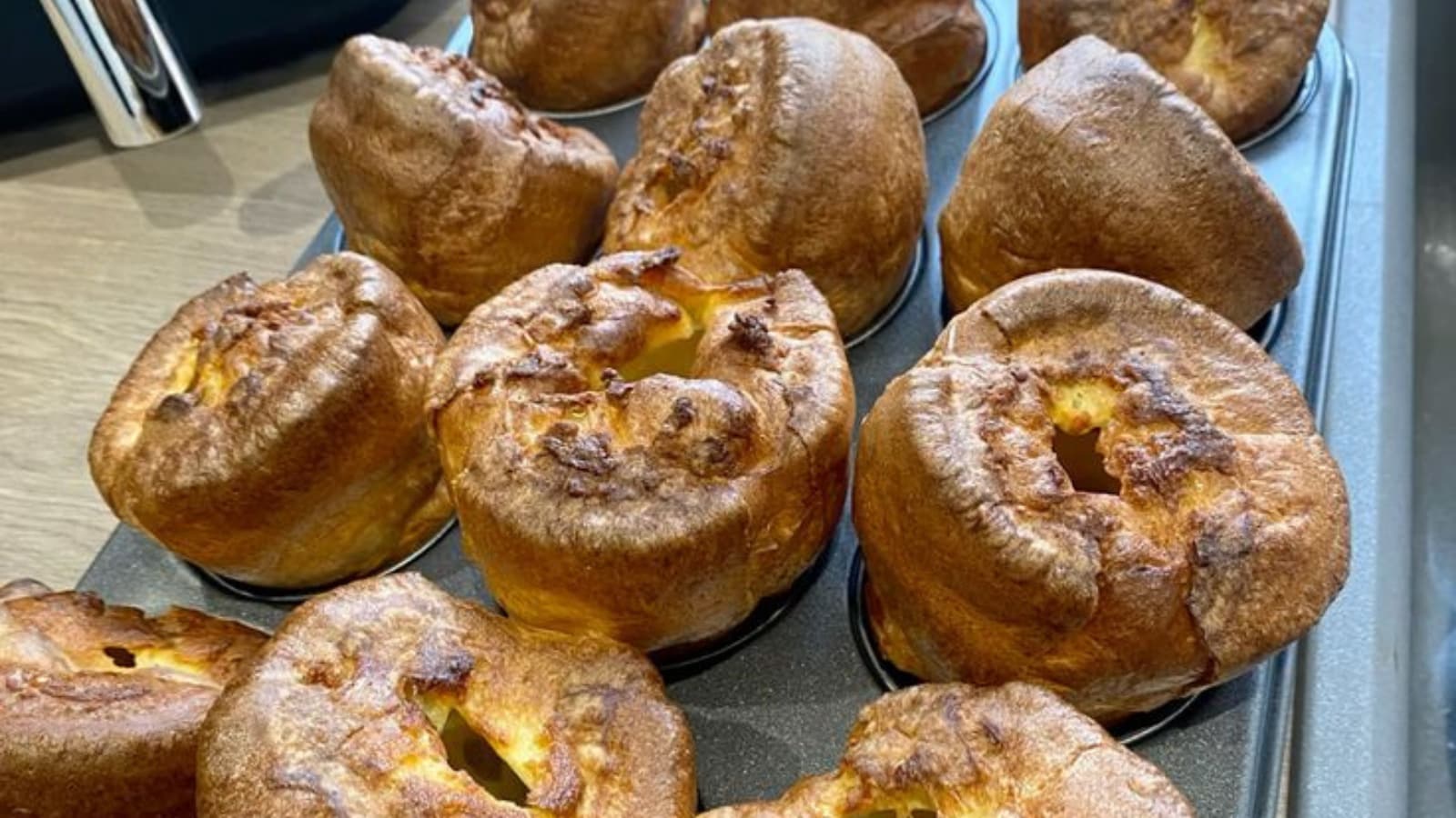 Now, spoon little oil into eight moulds of a deep muffin tin. Place the tin in the oven to heat. Fill the muffin moulds about half to two-thirds full with the batter. 