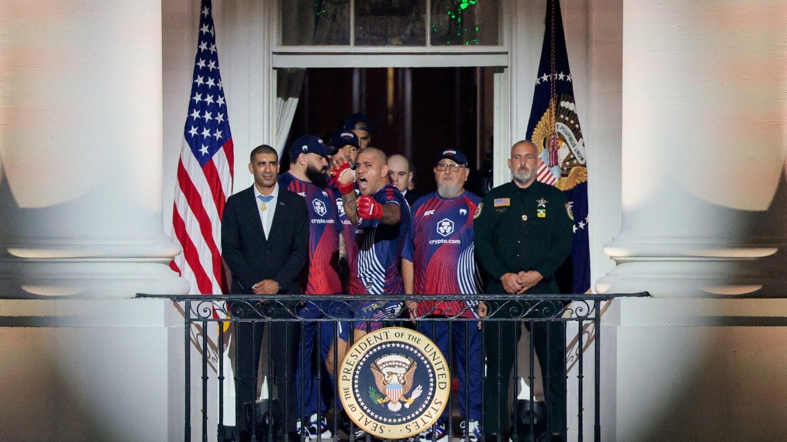 Alex Pereira gestures from the balcony of the White House ahead of his interim heavyweight championship bout against Ciryl Gane at UFC Freedom 250 on the South Lawn of the White House in Washington, D.C., U.S., June 14, 2026. REUTERS/Evan Vucci REFILE - CORRECTING ID FROM "AIEMANN ZAHA" TO "ALEX PEREIRA".