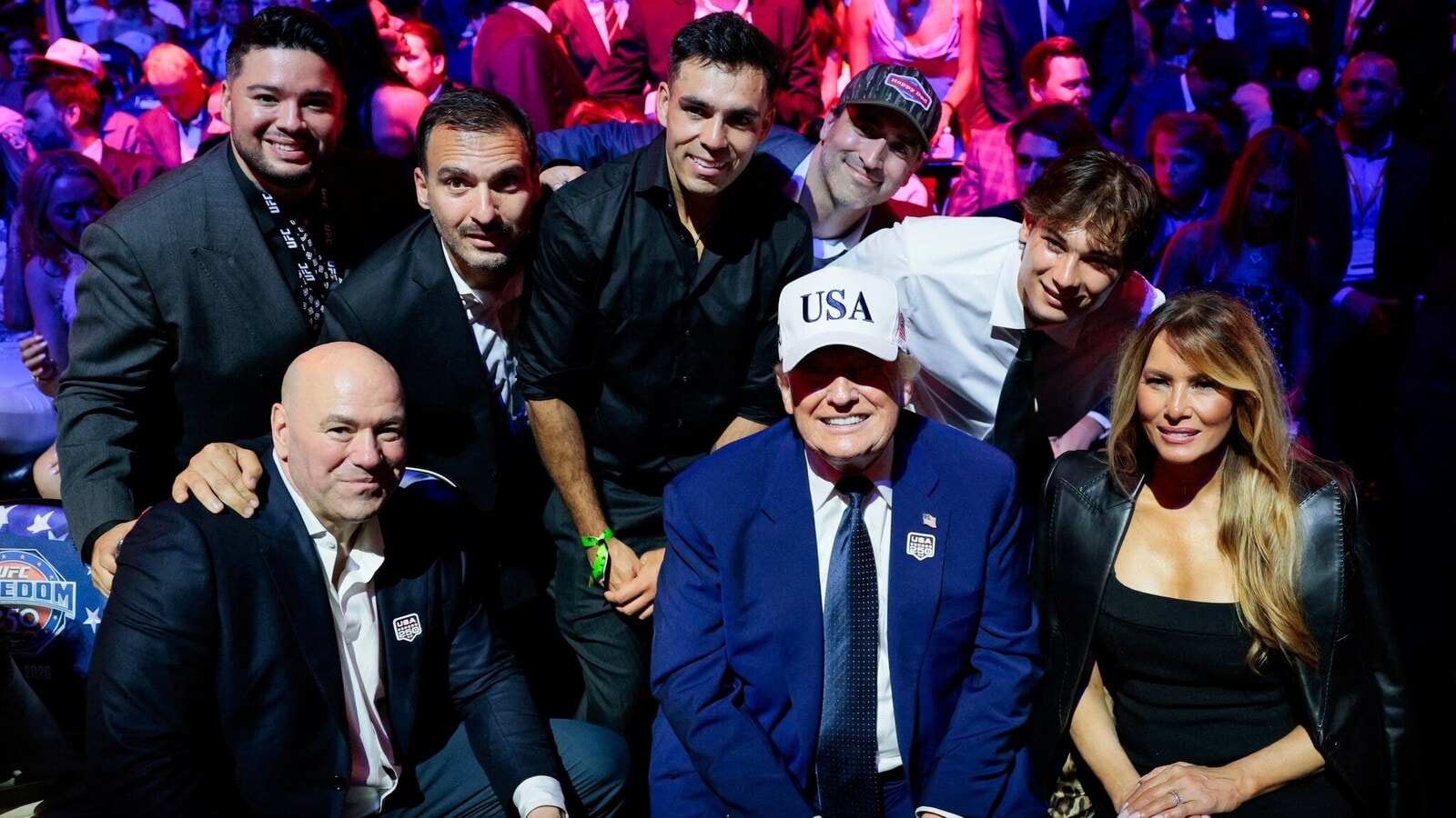 U.S. President Donald Trump smiles as he sits next to first lady Melania Trump and UFC CEO Dana White while posing for a photo with other guests during UFC Freedom 250 on the South Lawn of the White House in Washington, D.C., U.S., June 15, 2026. REUTERS/Evan Vucci/Pool