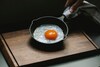 Wash & dry: To begin with, clean the iron tawa with hot water. Make sure to avoid any dishwashers or harsh detergents. Dry it completely to prevent rusting using a kitchen towel.Heat the tawa: Now, heat the tawa on medium flame for 2-3 minutes.Apply oil generously: Next, spread 1 tbsp of oil on the tawa. It is best to use any high-smoke-point oil (gingelly/sesame/groundnut/sunflower.