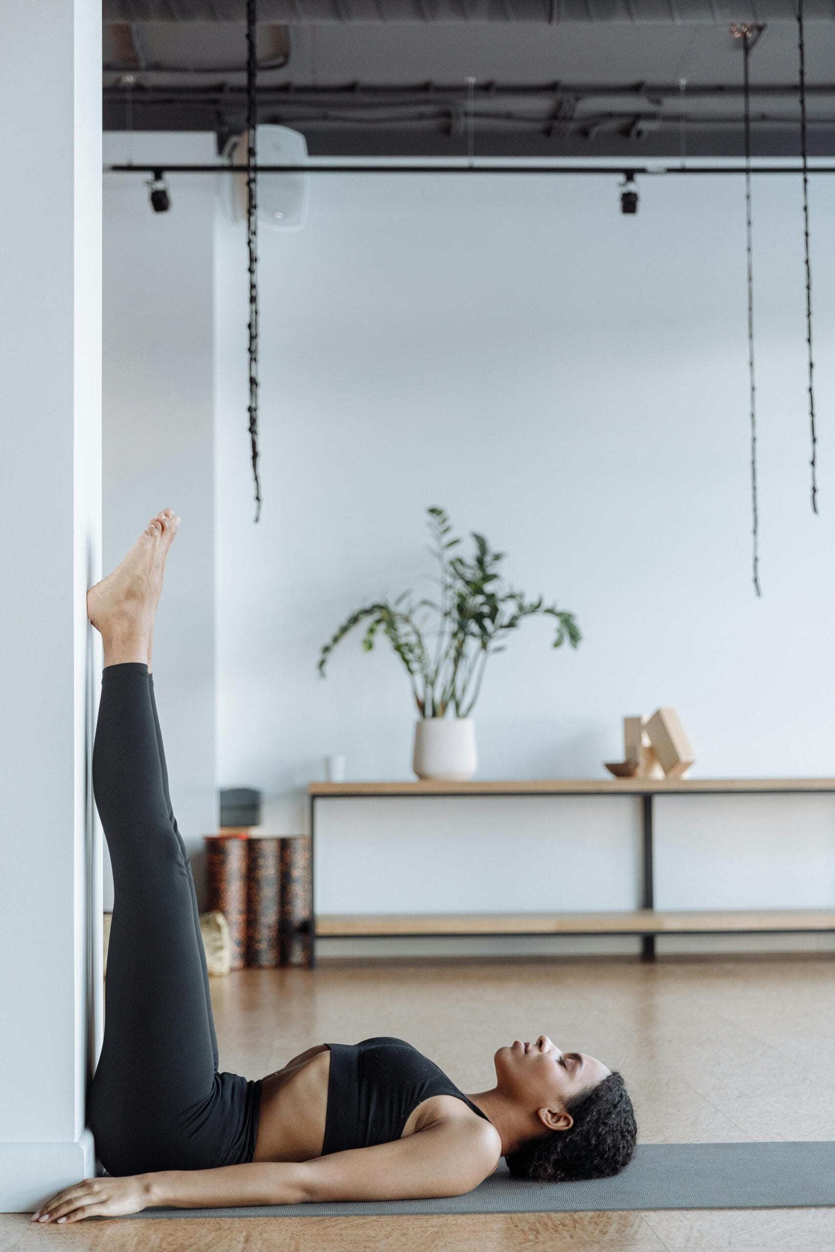 Legs-Up-the-Wall Pose (Viparita Karani): Lie on your back and extend your legs straight up against the wall or headboard. This effortless inversion drains pooled fluid from your lower limbs, relieves tired feet, and shifts your body into a deeply relaxing parasympathetic state.