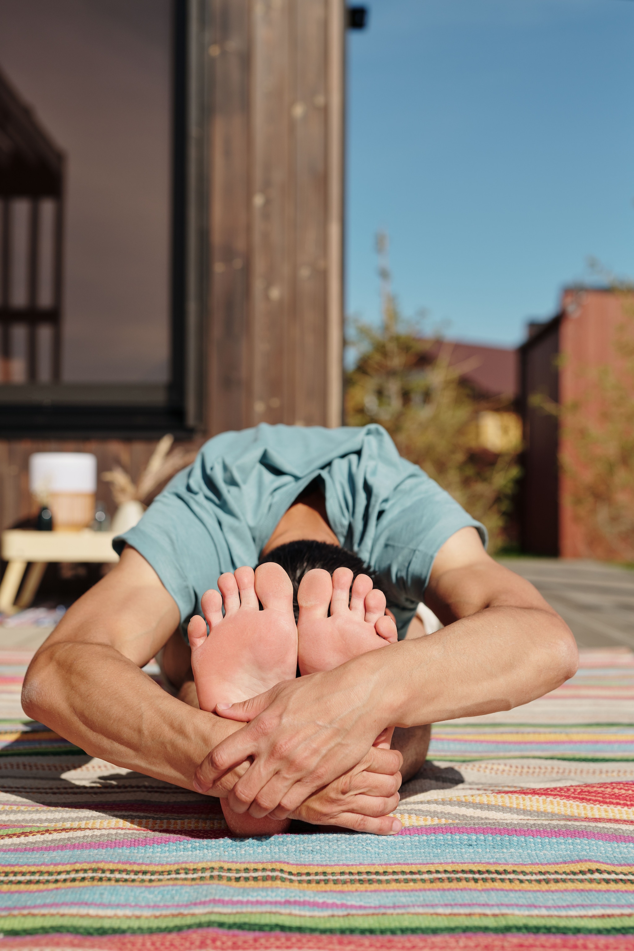 Seated Forward Fold (Paschimottanasana): Sit with your legs straight out and gently hinge forward from your hips toward your toes. This soothing movement stretches the entire back of your body, lowers your heart rate, and turns your attention inward for a peaceful mind.