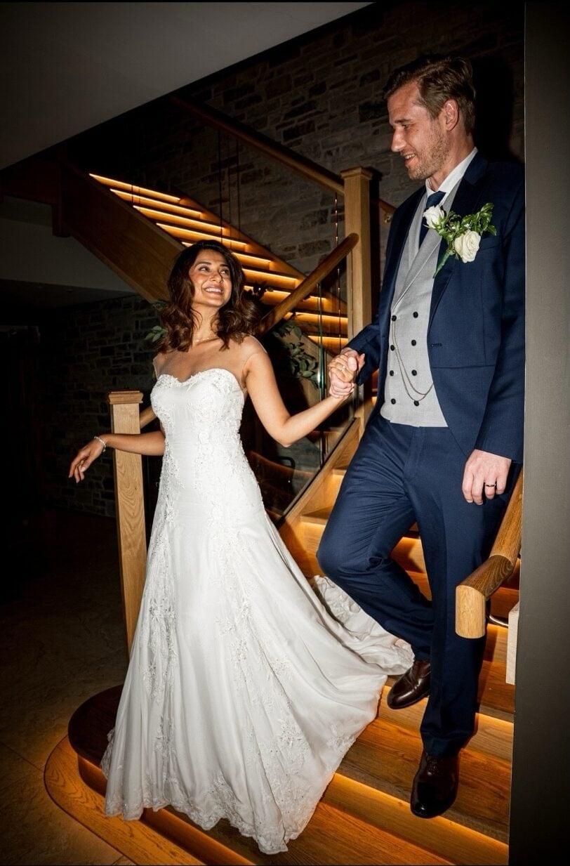 The intricate detailing flowed into a voluminous layered tulle skirt, giving the dress a timeless fairytale-inspired silhouette. She completed the look with a long cathedral-style veil.