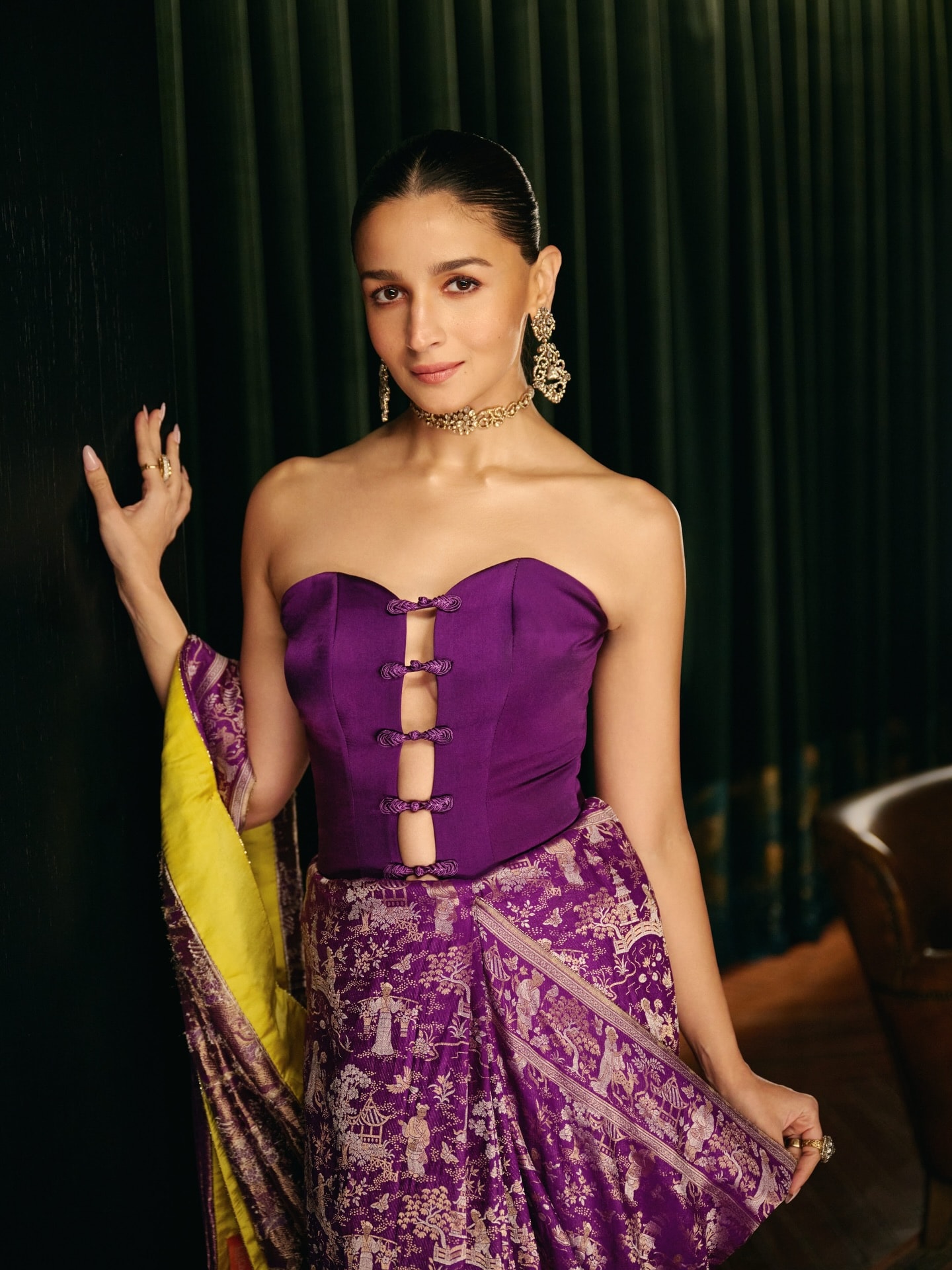 Alia Bhatt made a bold statement with a strapless corset-inspired blouse featuring a sweetheart neckline and eye-catching loop-and-knot detailing down the front. Paired with a rich Banarasi saree, it blends modern glamour with timeless tradition.