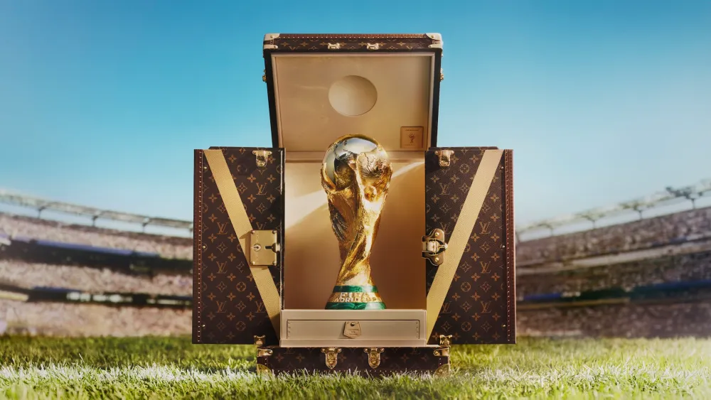 The signature gold and brown Monogram canvas remains untouched — a design constant across every edition. Crafted by Louis Vuitton's artisans at the historic Asnières-sur-Seine workshops near Paris, the trunk stays true to the house's most recognisable material. (Credit: Louis Vuitton)