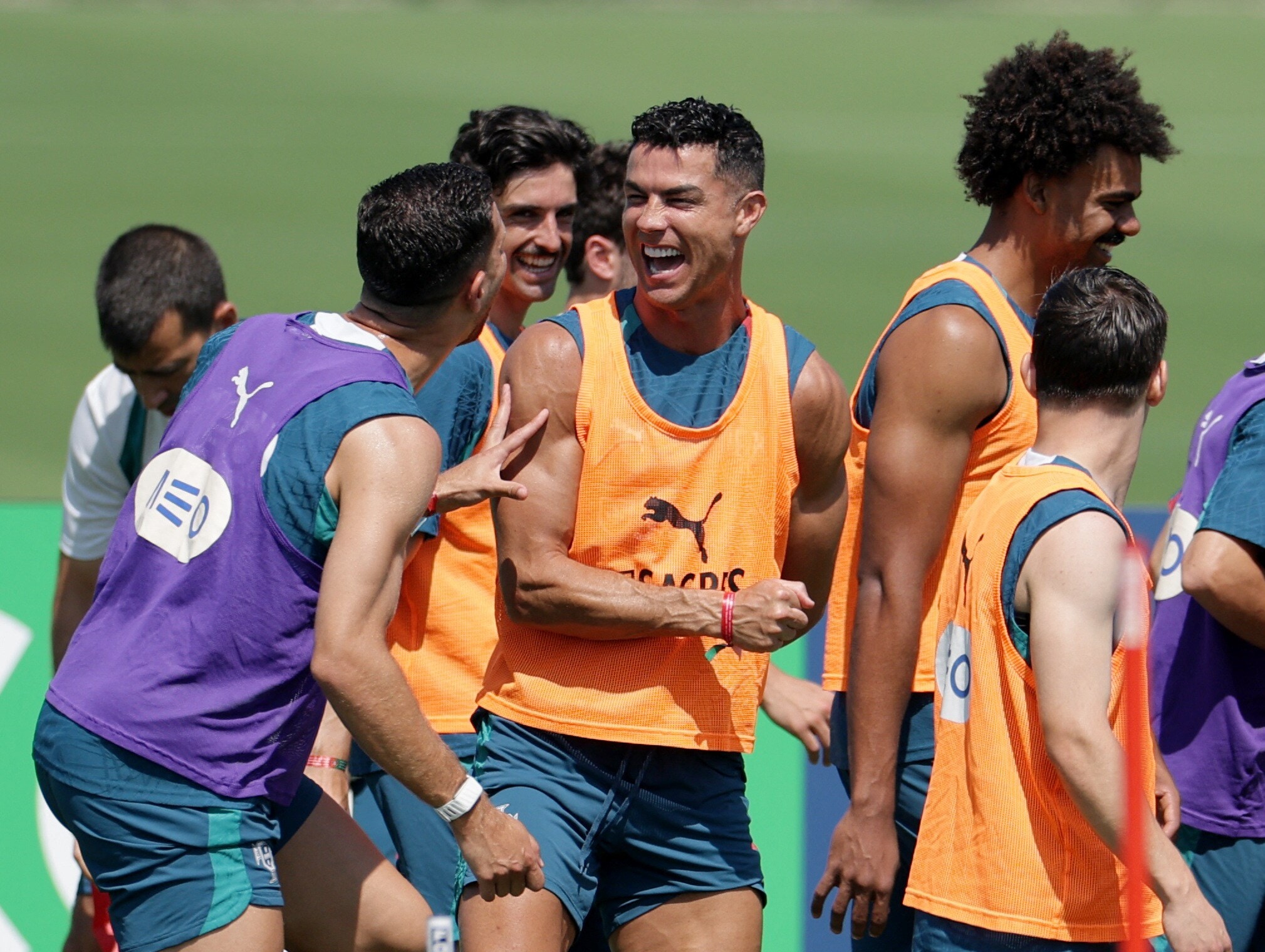 cristiano ronaldo laughing with Portuguese teammates during a warmup match