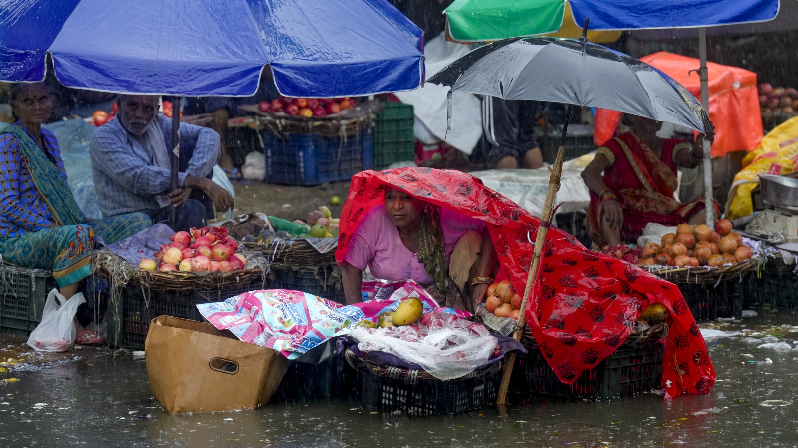 The IMD placed Delhi under a red alert as relentless monsoon showers triggered widespread waterlogging and traffic chaos. (Image: PTI) The IMD placed Delhi under a red alert as relentless monsoon showers triggered widespread waterlogging and traffic chaos. (Image: PTI)