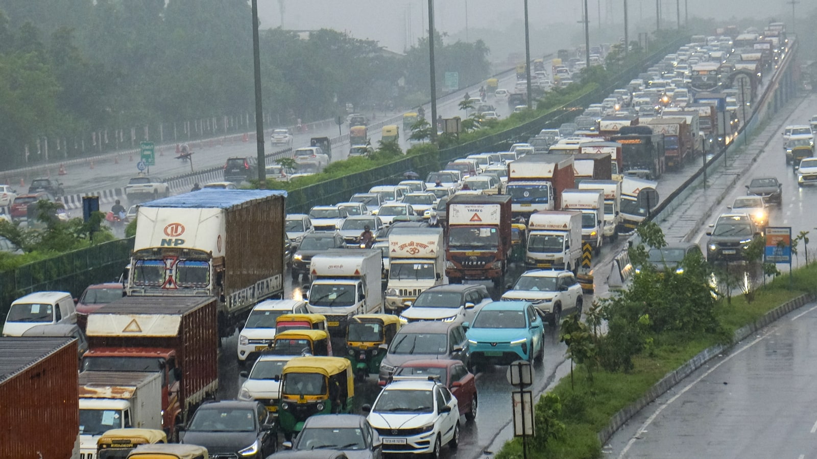 The rain offered respite from the heat but also brought flooded streets, gridlocked traffic and a difficult commute for thousands across Delhi-NCR. (Image: PTI) The rain offered respite from the heat but also brought flooded streets, gridlocked traffic and a difficult commute for thousands across Delhi-NCR. (Image: PTI)