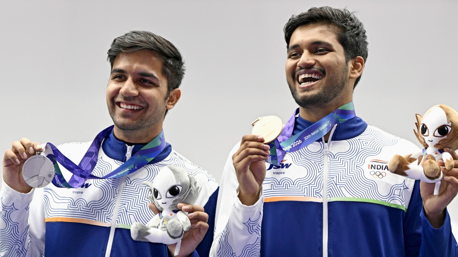 India's silver medalist Himanshu Dhillon, left, and bronze medalist Rudrankksh Balasaheb Patil hold their medal, following the 10-meter air rifle men individual event at the Asian Games in Toyota, Japan, Monday, Sept. 21, 2026. (Kasumi Fukudome/Kyodo News via AP)