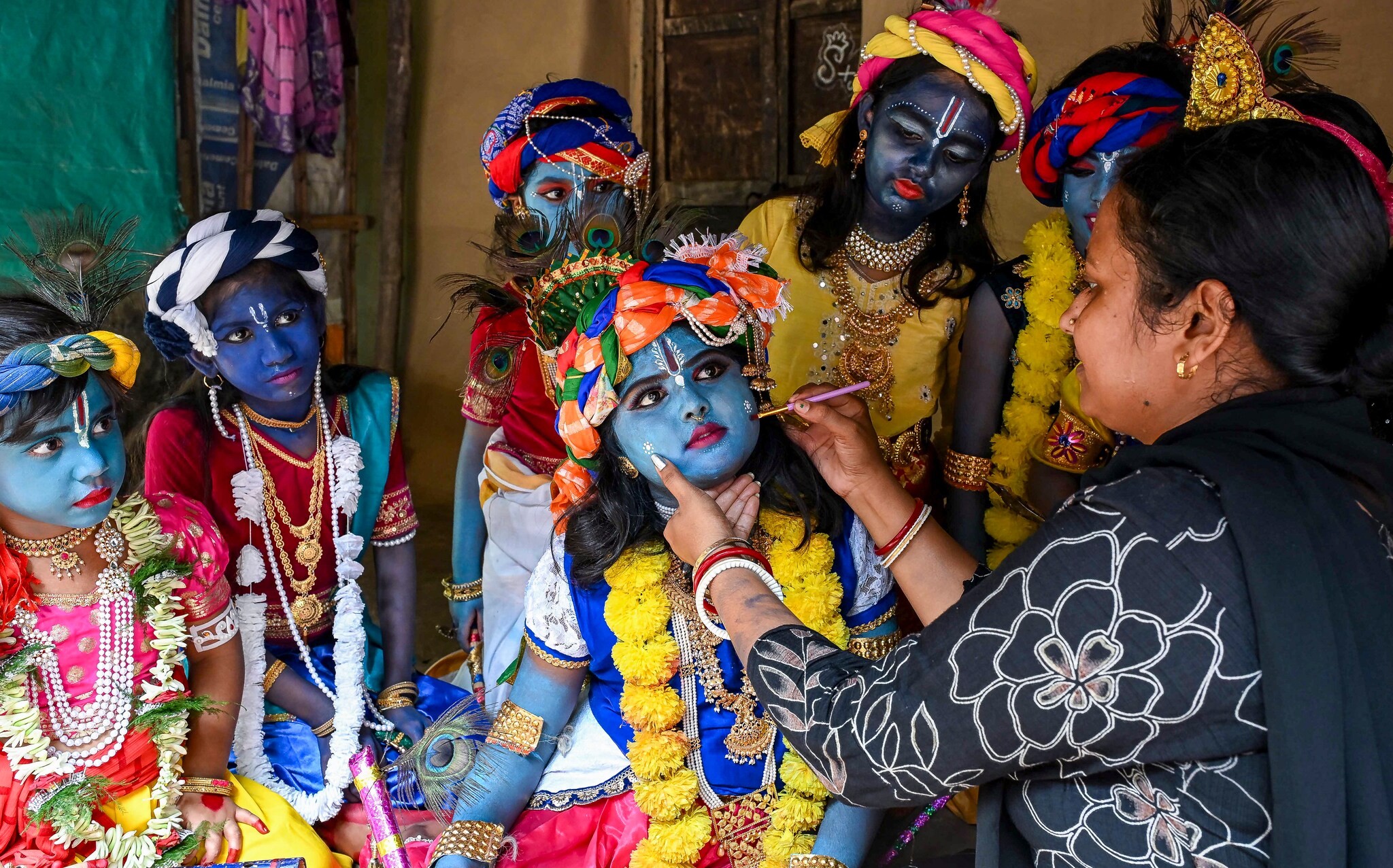 A woman applies makeup on a child dressed as Lord Krishna during a celebration on the eve of Janmashtami in West Bengal. (PTI Photo) A woman applies makeup on a child dressed as Lord Krishna during a celebration on the eve of Janmashtami in West Bengal. (PTI Photo)