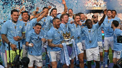 Manchester City's English defender #02 Kyle Walker holds aloft the Premier League trophy during the presentation ceremony following the English Premier League football match between Manchester City and West Ham United at the Etihad Stadium in Manchester, north west England, on May 19, 2024. (AFP)