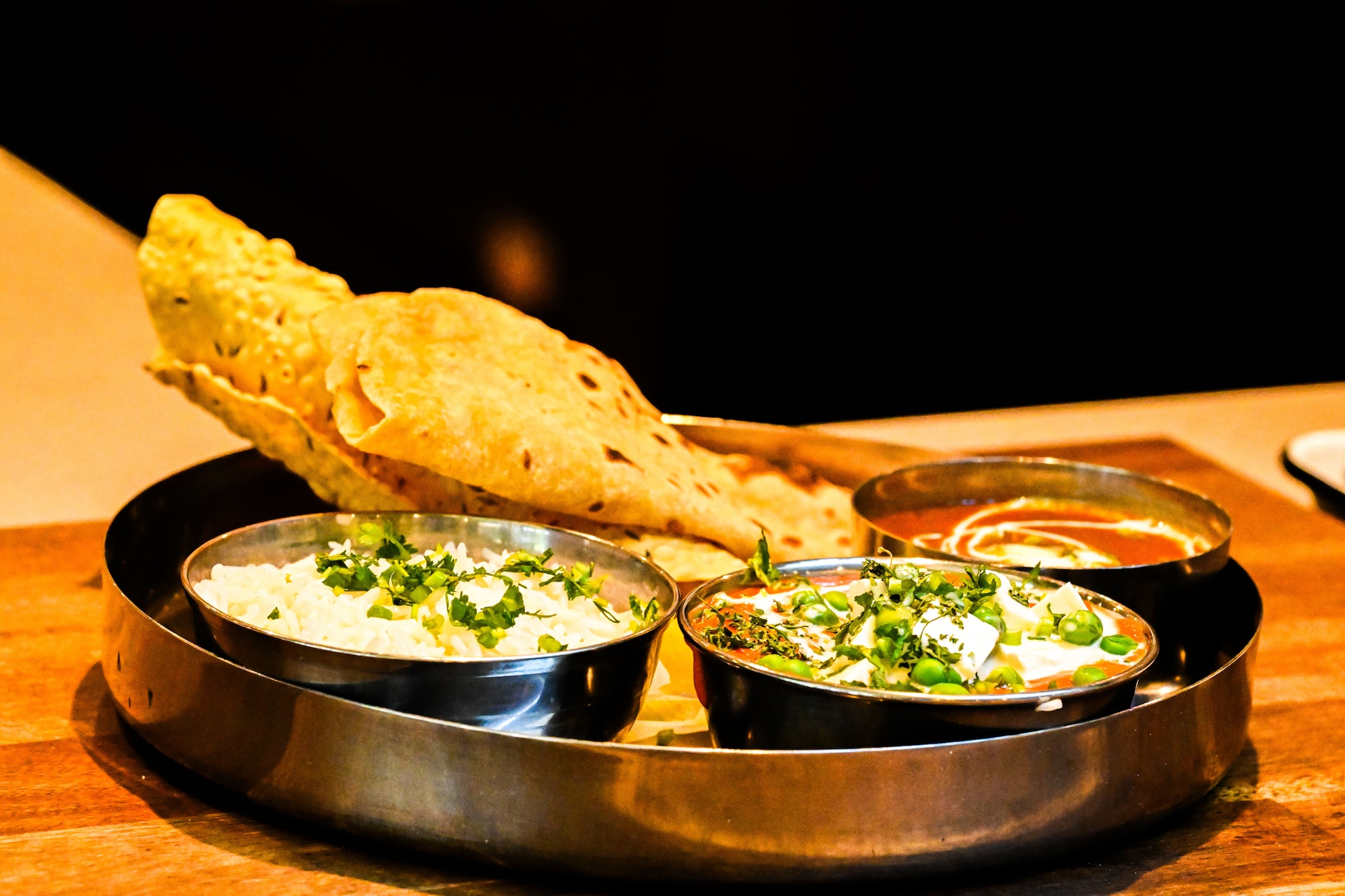 Bhakri Dal: A staple of the Gujarat’s traditional platter, this wholesome and flavourful combination pairs a flatbread made from jowar or bajra flour with dal, creating a meal rich in protein, iron, and authentic taste. (Image: Pexels)