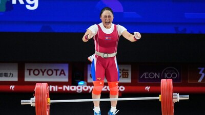 Ri Song Gum of North Korea celebrates after a successful lift as she competes during the women's 49kg weightlifting final at the Asian Games (Picture credit: AP)