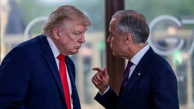 US President Donald Trump speaks with Canadian Prime Minister Mark Carney at a working lunch with leaders of the G7 and the Middle East, in Evian-les-Bains, France. (Source: Reuters)
