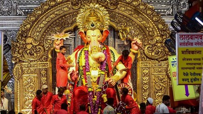 Devotees offer prayer to an idol of Lord Ganesh during the Ganesh Chaturthi festival, at the pandal of Lalbaugcha Raja in Mumbai. (PTI Photo)
