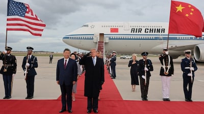 US President Donald Trump salutes next to Chinese President Xi Jinping as he arrives ahead of a state visit at Joint Base Andrews, Maryland. (Reuters photo)