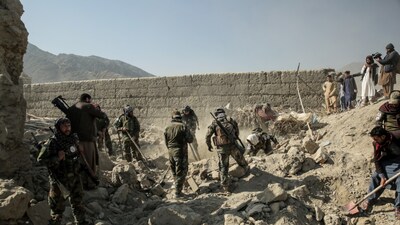 Taliban security personnel search for victims after an overnight Pakistani air strike hit a residential area at the Girdi Kas village in Bihsud district, Nangarhar province on February 22, 2026. (AFP photo)