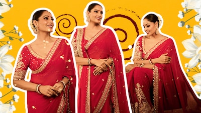 Bipasha wore a matching red blouse with a plunging sweetheart neckline and half sleeves accented by gold embroidery, it complemented the saree without competing with its ornate detailing.