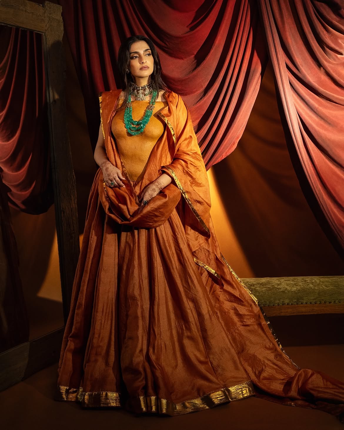 Sonam Kapoor: The actress turned heads in a crushed Khadi lehenga in a beautiful rust hue. The lehenga featured densely pleated ghera and a broad gold gota-work border around the hemline. It was paired with a matching dupatta that she wore pleated on her shoulders with a similar but thinner gold gota-patti design on the borders. (Image: Instagram/@hrishidoeshair) Sonam Kapoor: The actress turned heads in a crushed Khadi lehenga in a beautiful rust hue. The lehenga featured densely pleated ghera and a broad gold gota-work border around the hemline. It was paired with a matching dupatta that she wore pleated on her shoulders with a similar but thinner gold gota-patti design on the borders. (Image: Instagram/@hrishidoeshair)
