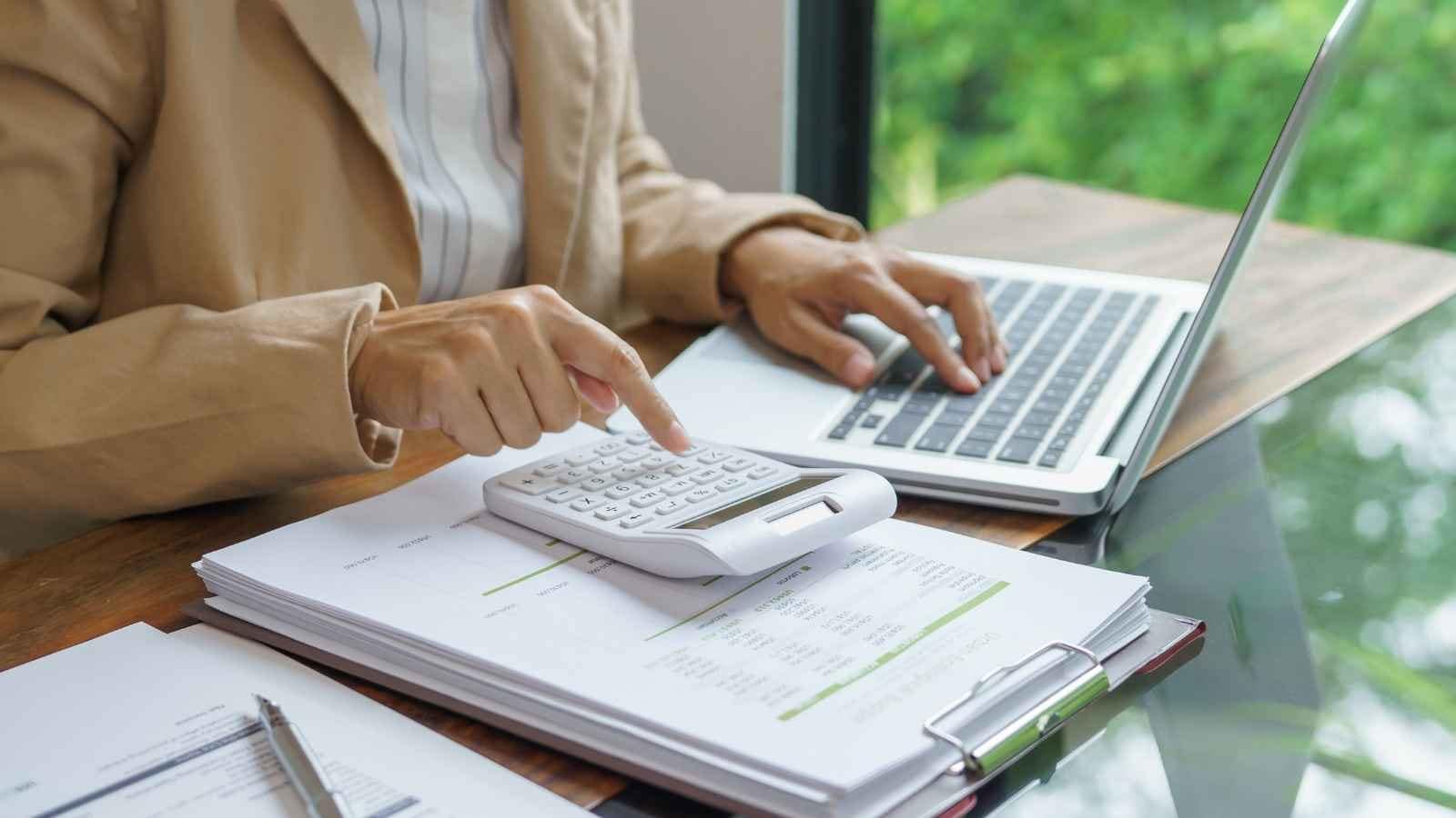 Review your budget monthly to accommodate changing income, expenses and priorities while keeping your spending aligned with long-term financial goals.Image Suggestion: A couple discussing household finances together over a financial planning ledger.