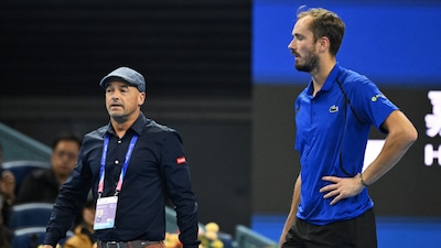 Russia's Daniil Medvedev (R) is escorted by an ATP official after Medvedev was disqualified for hitting a ball into the stands, injuring a spectator, during the men’s singles semi-final against Serbia’s Novak Djokovic at the China Open tennis tournament in Beijing on October 5, 2026. (Photo by GREG BAKER / AFP)
