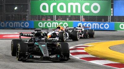 Mercedes' British driver George Russell (front) drives during the sprint qualifying session ahead of the Formula One Singapore Grand Prix at the Marina Bay Street Circuit in Singapore on October 9, 2026. (Photo by Roslan RAHMAN / AFP)