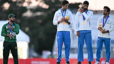 Gold medallists India (R) and silver medallists Pakistan (L) stand on the podium during the victory ceremony for the men's cricket in the 2026 Asian Games at the Korogi Athletic Park in Nisshin on October 3, 2026. (Photo by ANDREW CABALLERO-REYNOLDS / AFP)
