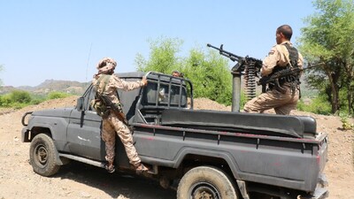 Members of the Saudi-backed Yemeni government forces ride on a military pick-up vehicle as they patrol a road leading to a frontline of clashes with Iran-aligned Houthi fighters, in Taiz province, Yemen. (IMAGE: REUTERS)