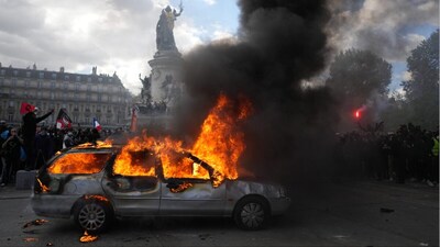 A car burns at Republique square during a protest against rising living costs, joining students' grievances, in Paris (Photo: AP)