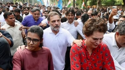 Neha Bora with Rahul Gandhi and Priyanka Gandhi Vadra during the protest in Delhi. (X)