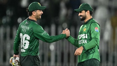 Pakistan's captain Sahibzada Farhan (R) and wicketkeeper Khawaja Nafay celebrate their team's win at the end of the second T20 international cricket match between Pakistan and Sri Lanka at the Rawalpindi Cricket Stadium in Rawalpindi on October 11, 2026. (Photo by Aamir QURESHI / AFP)