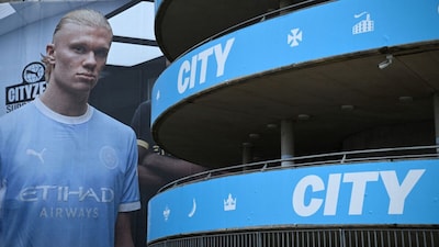 A poster of Manchester City striker Erling Haaland is pictured outside the Etihad Stadium, the club's home ground (Picture credit: AFP)