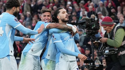 Rayan Cherki celebrates after scoring his side's third goal during the English Premier League match against Liverpool (Picture credit: AP)