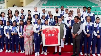 Narendra Modi receives a gift from the Indian women's hockey team (Picture credit: Screengrab from X)