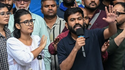 Cockroach Janta Party (CJP) founder Abhijeet Dipke (R) and All India Students' Association (AISA) president Neha Bora (2L) gesture during a press conference in New Delhi. (AFP photo)