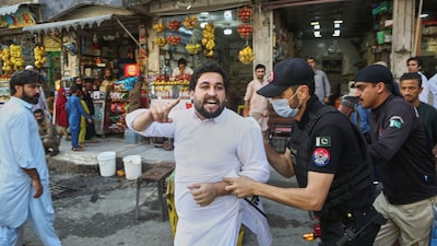 Police officers detain a supporters of imprisoned former Prime Minister Imran Khan's party during a protest against the Pakistani president declared a state of emergency in northwestern Khyber Pakhtunkhwa province and suspended its government. (Image: AP)