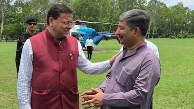 CM Pushkar Singh Dhami with Dinesh Arya (right).  (NW18 File Photo)