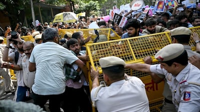 Protesters scuffle with police personnel during a demonstration against India's Chief Election Commissioner Gyanesh Kumar in New Delhi. (AFP)