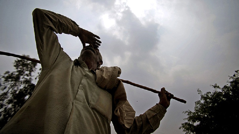 An Indian farmer looks at an overcast sky on the outskirts of Jammu, India, Tuesday, July 24, 2012. Indians have grown increasingly desperate waiting for the long-delayed monsoon, the annual rains that replenish rivers and quench crops to keep this agricultural nation of 1.2 billion fed through the year. So far the rains have fallen at least 22 percent below the national average. (AP Photo/Channi Anand)