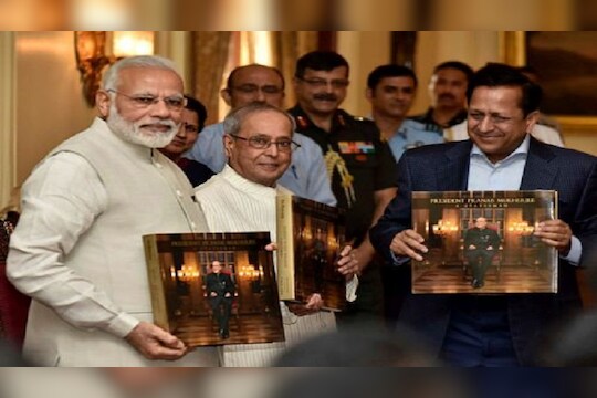 New Delhi:  Prime Minister, Narendra Modi releasing the photo book titled President Pranab Mukherjee - A Statesman and presenting first copy to the President,  Pranab Mukherjee, at Rashtrapati Bhawan, in New Delhi on Sunday. PTI Photo(PTI7_2_2017_000216B)