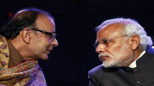 Prime Minister Narendra Modi (R) listens to Finance Minister Arun Jaitley during the Global Business Summit in New Delhi January 16, 2015. REUTERS/Anindito Mukherjee/Files