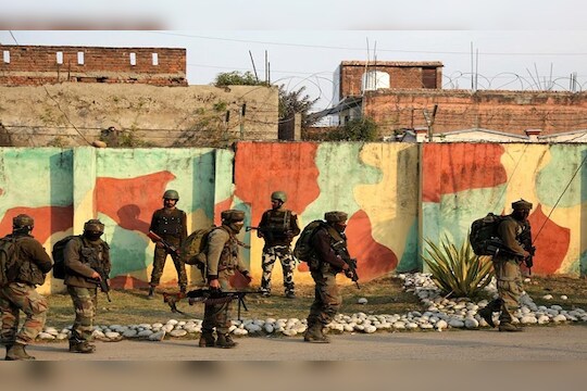 Indian Army soldiers surround Sunjwan Army camp in Jammu, India, Saturday, Feb.10, 2018. A group of militants in Indian Kashmir opened fire Saturday inside an army camp in the disputed region, police said. The attack began early in the morning and it was unclear how many gunmen were involved, (AP Photo/Channi Anand)