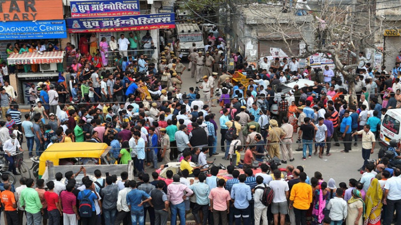 New Delhi: Police personnel and people outside the street leading to the house, where 11 members of a family- four men, three women and four girls- were found hanging from an iron grill, in Burari area of New Delhi on Sunday, July 1, 2018. (PTI Photo/Shahbaz Khan) (PTI7_1_2018_000094B)