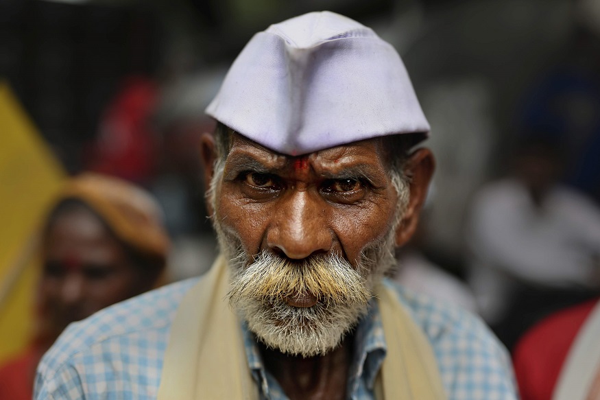 An Indian protester from the Indian state of Maharastra listens to a speaker highlighting the problems faced by Indian farmers, workers and agricultural laborers, at Jantar Mantar, an area near the Indian parliament where citizens from across the country assemble for protests, in New Delhi, India, Wednesday, Sept. 5, 2018. Thousands of farmers, workers and agricultural laborers march through New Delhi streets demanding better wages, more jobs, better prices for farm produce and an end to privatization of state-run companies. Agriculture employs more than half of India's 1.3 billion people, but its shrinking earnings means it now only adds 15 percent to India's economy. (AP Photo/Altaf Qadri)