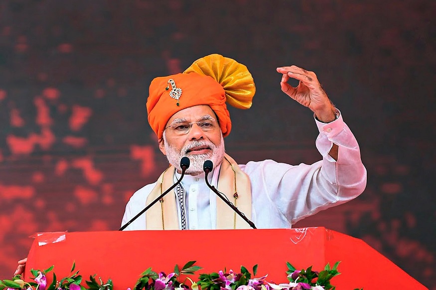 Anand: Prime Minister Narendra Modi addresses a public meeting during inauguration of Anand Agricultural University’s Incubation Centre cum Centre of Excellence in Food Processing, in Anand, Gujarat, September 30, 2018. Gujarat Chief Minister Vijay Rupani is also seen. (PIB Photo via PTI) (PTI9_30_2018_000072B)
