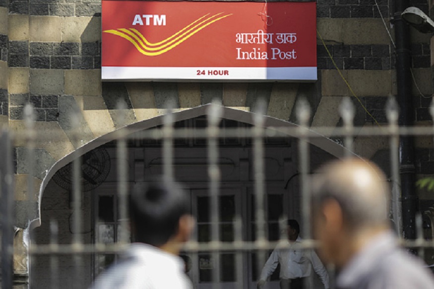 Signage for India Post's automated teller machine (ATM) services is displayed at the postal operator's head office in Mumbai, India, on Thursday, Jan. 7, 2016. The world's largest post office network is planning to ramp up its financial services across India, triggering a race among commercial banks to set up partnerships to reach remote areas that have been unprofitable. Photographer: Dhiraj Singh/Bloomberg