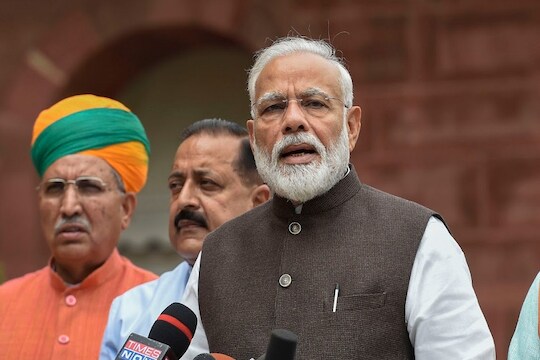 **EDS: RPT WITH CORR IN BYLINE** New Delhi: Prime Minister Narendra Modi addresses the media as he arrives for the first session of 17th Lok Sabha, at Parliament, in New Delhi, Monday, June 17, 2019. Minister of Parliamentary Affairs Pralhad Joshi, MoS Parliamentary Affairs, Heavy Industries and Public Enterprises Arjun Ram Meghwal and MoS in the Prime Minister's Office Jitendra Singh are also seen. (PTI Photo/Kamal Singh) (PTI6_17_2019_000032B)