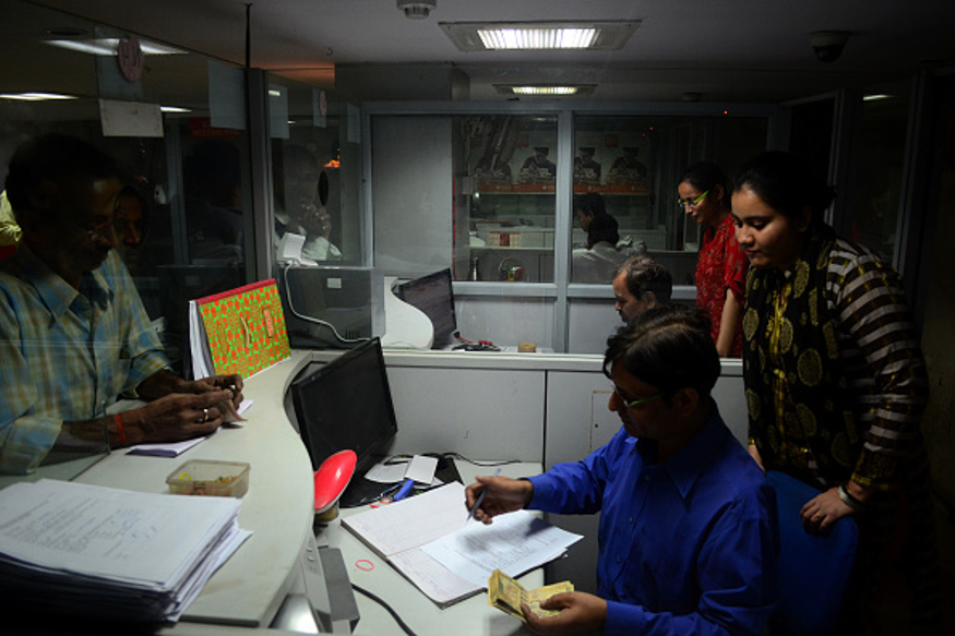 indian people stand in queue to exchange their 500 and 1000 rupee notes as bank officials seen working , in a bank, in Allahabad on November 10,2016..On the first day of the opening of banks ,Huge rush and long queues were witnessed across the country today as people get in line to get rid of their 500 and 100 rupee notes. The recent demonetization move had taken people unawares and they have been facing problems in transacting day to day business in the absence of ample cash. (Photo by Ritesh Shukla/NurPhoto)