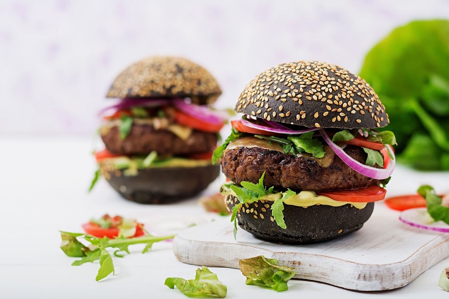 **EDS: WITH STORY DES 7** New Delhi: A charcoal burger on display in New Delhi. The popularity of charred foods, the acceptance of squid ink as more than a novelty ingredient, and the rise of activated charcoal as a health food has given a whole new concept of black food in the culinary industry. (PTI Photo) (PTI7_10_2019_000043B)