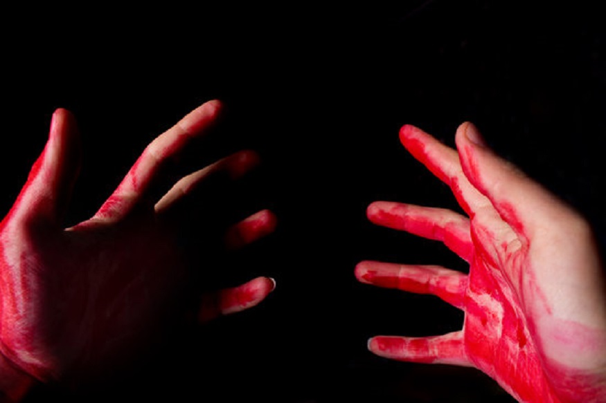 Bloody theme lone murderer: the murderer shows bloody hands and experiencing depression and pain